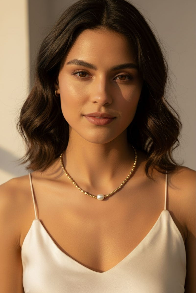 Model wearing 18K gold plated necklace with a pearl pendant.