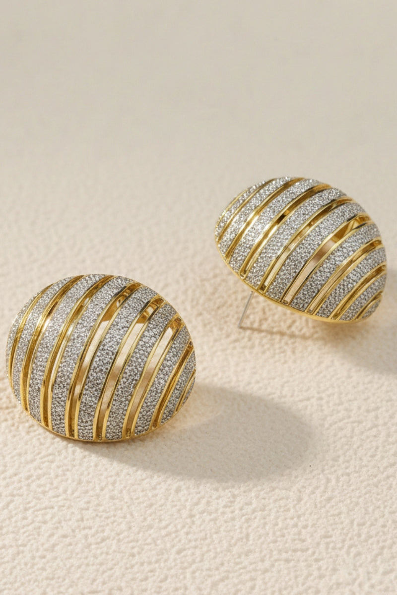 Chunky ribbed two-tone gold and silver dome earrings, mixed metal jewelry trend 2026.
