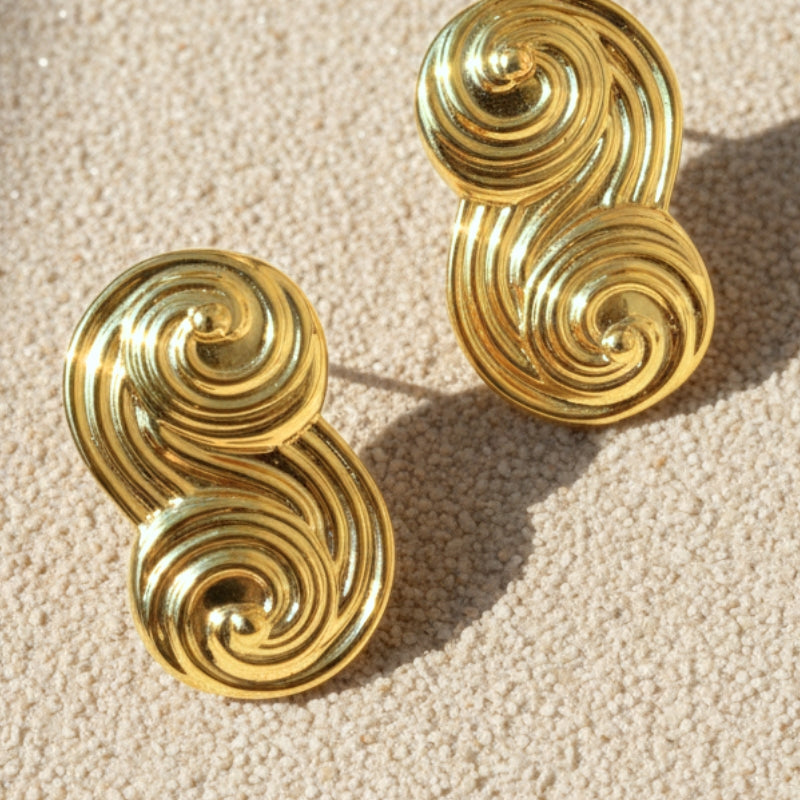 Close-up of gold Seraphina infinity-inspired S-curve stud earrings