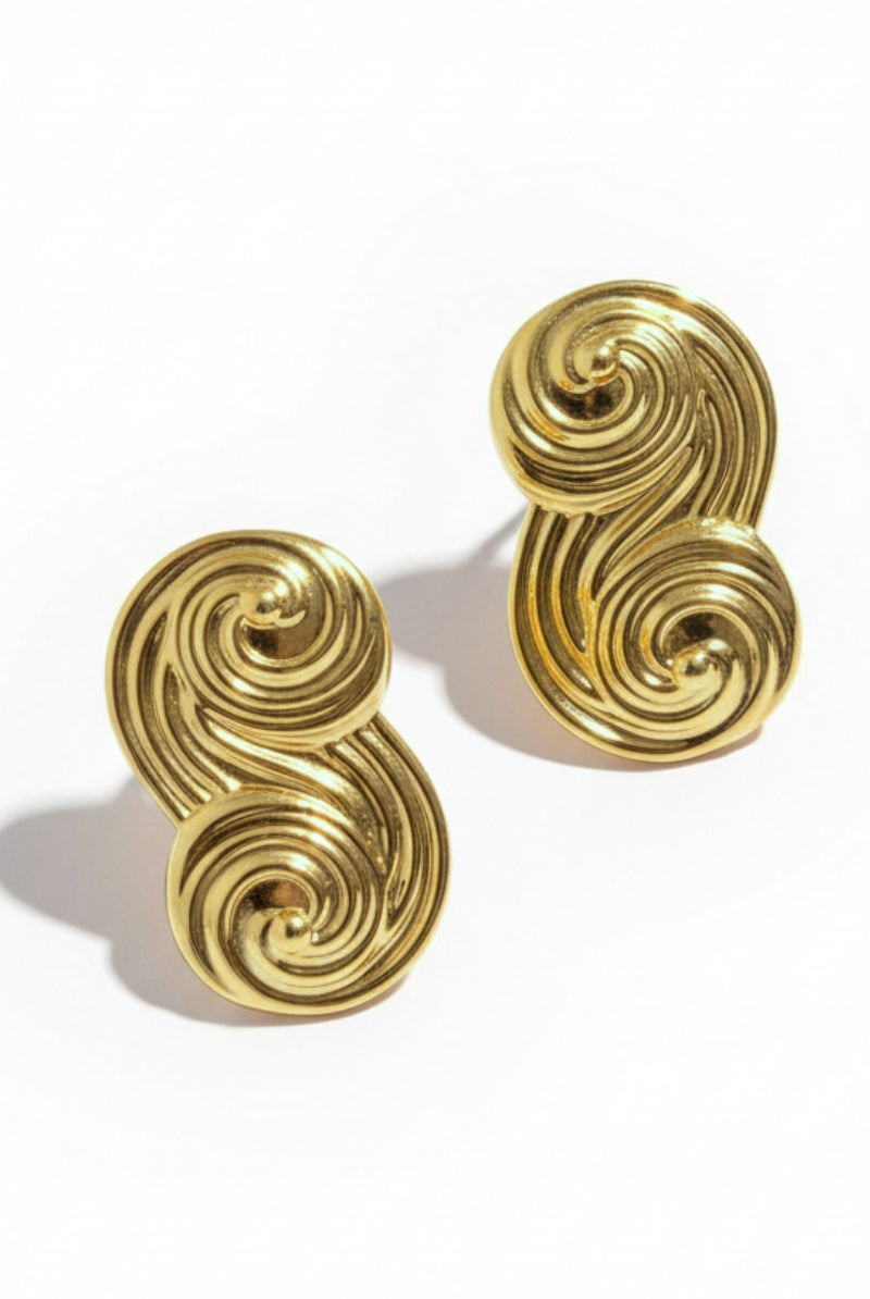 Close-up product shot of Seraphina Sculptural Swirl Earrings, textured gold ribbon design, high-quality infinity studs.