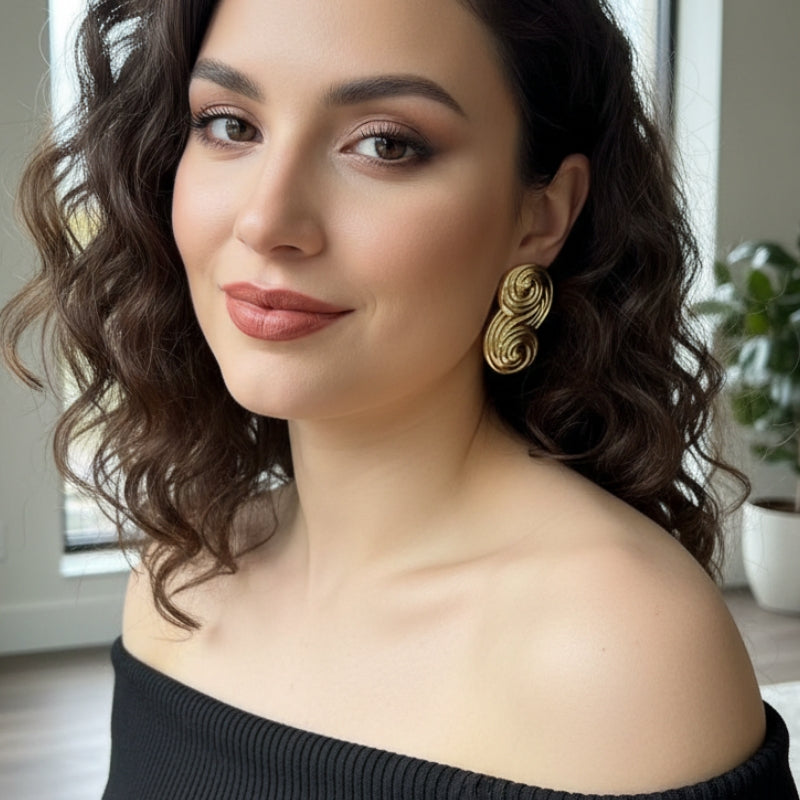 Pair of gold Seraphina infinity-inspired sculptural S-curve stud earrings