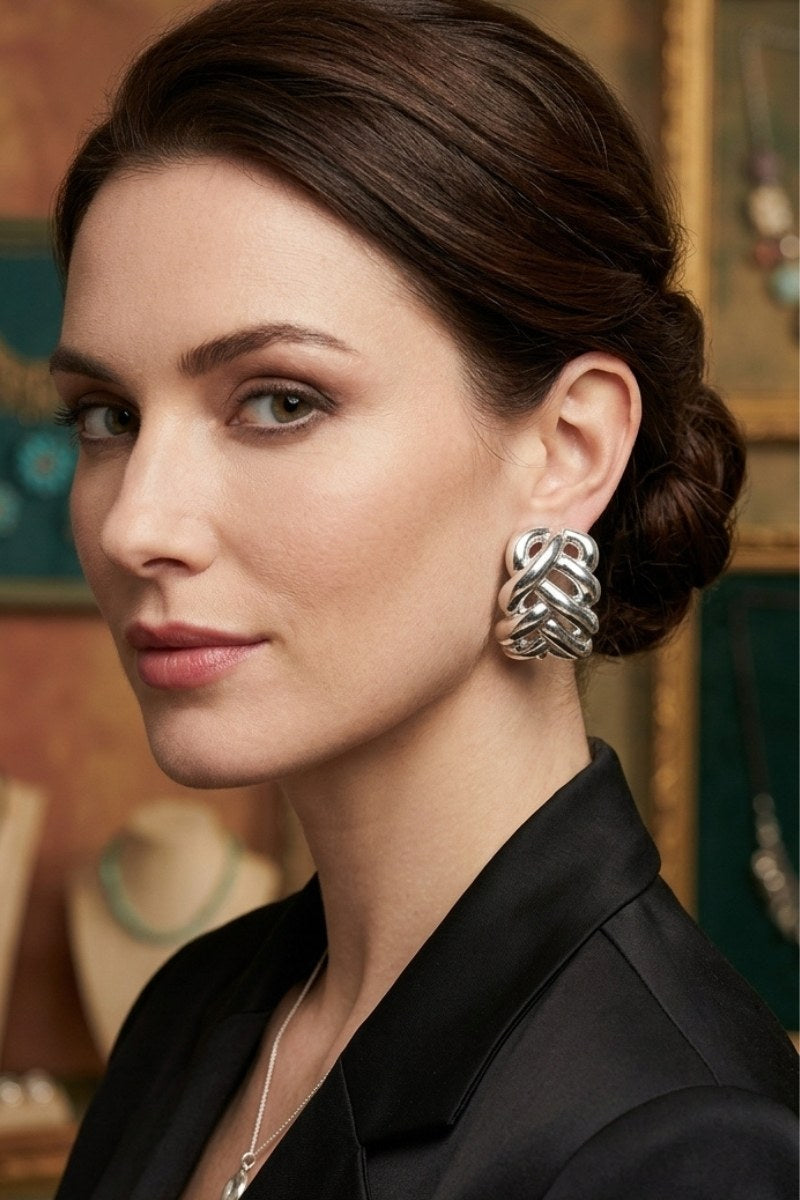Model wearing braided liquid silver half-hoop earrings, view 2