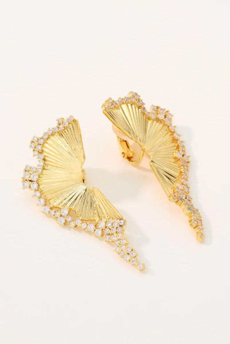 Studio flatlay of the Chrysalis 18K gold plated wing earrings showcasing the detailed ribbed texture and the back stud and clip-on mechanisms.