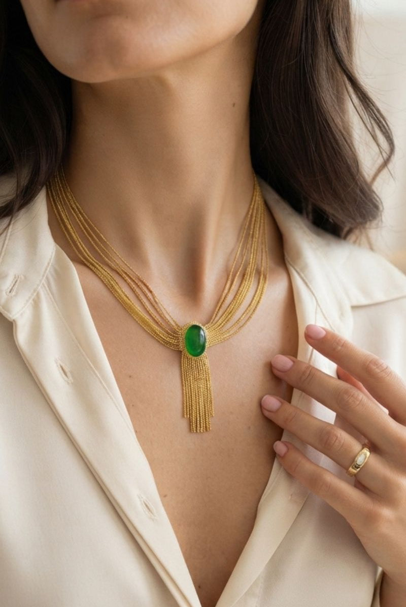 Elegant evening styling of Eclipse green synthetic crystal statement necklace with gold fringe chain details
