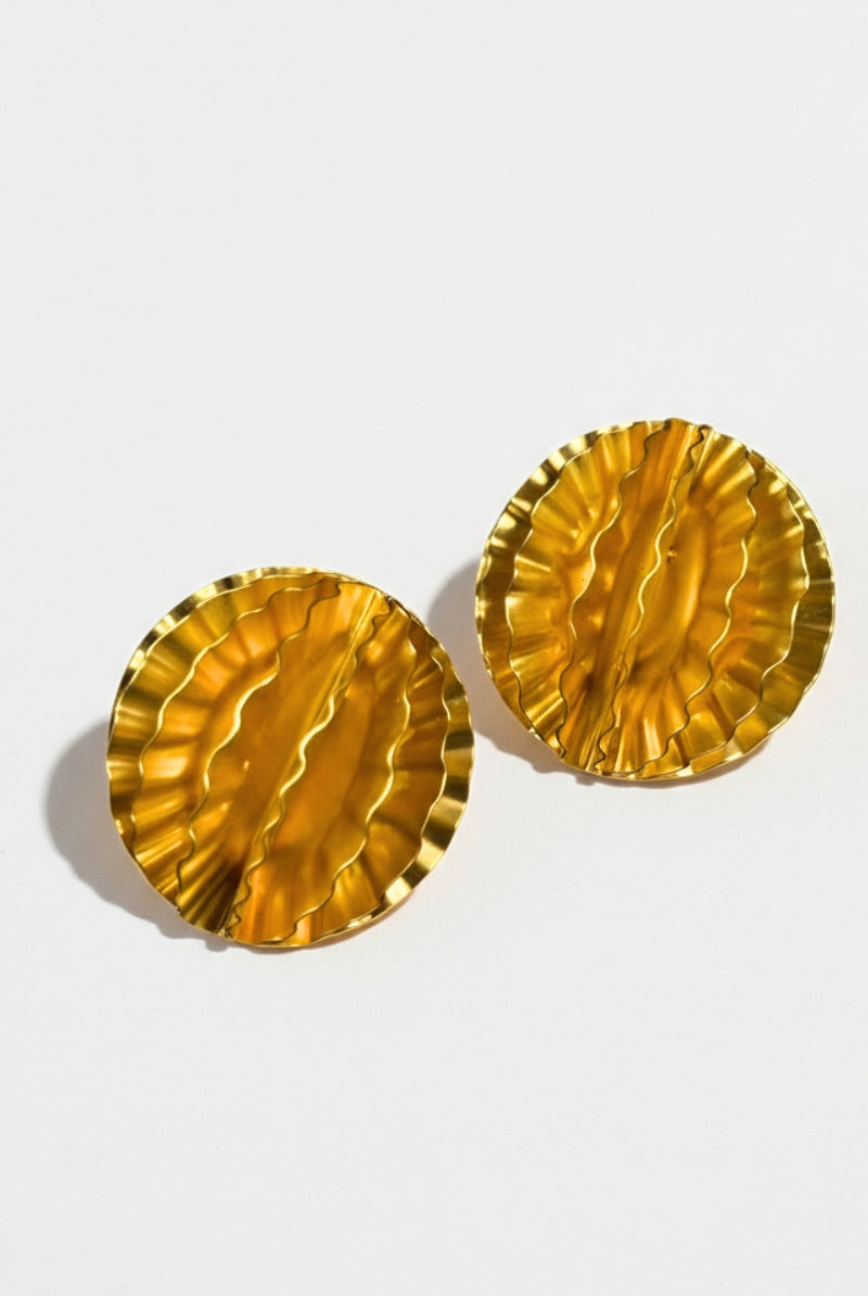Close-up of gold-plated honeycomb earrings showing the intricate pleated texture and high-shine metallic finish.