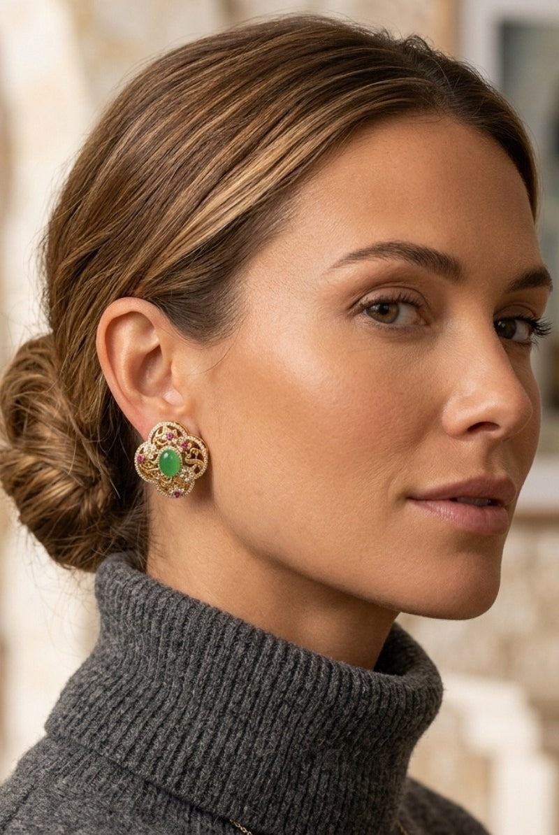 Model wearing green crystal quatrefoil stud earrings, view 2