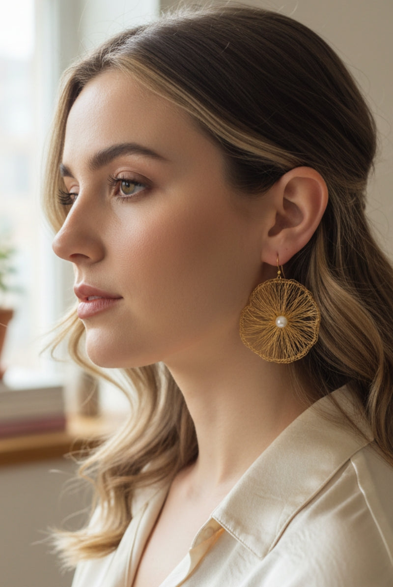Portrait of a model with wavy hair showcasing the shimmering texture of All Glows lightweight wire-crocheted earrings, a must-have for London fashion events.
