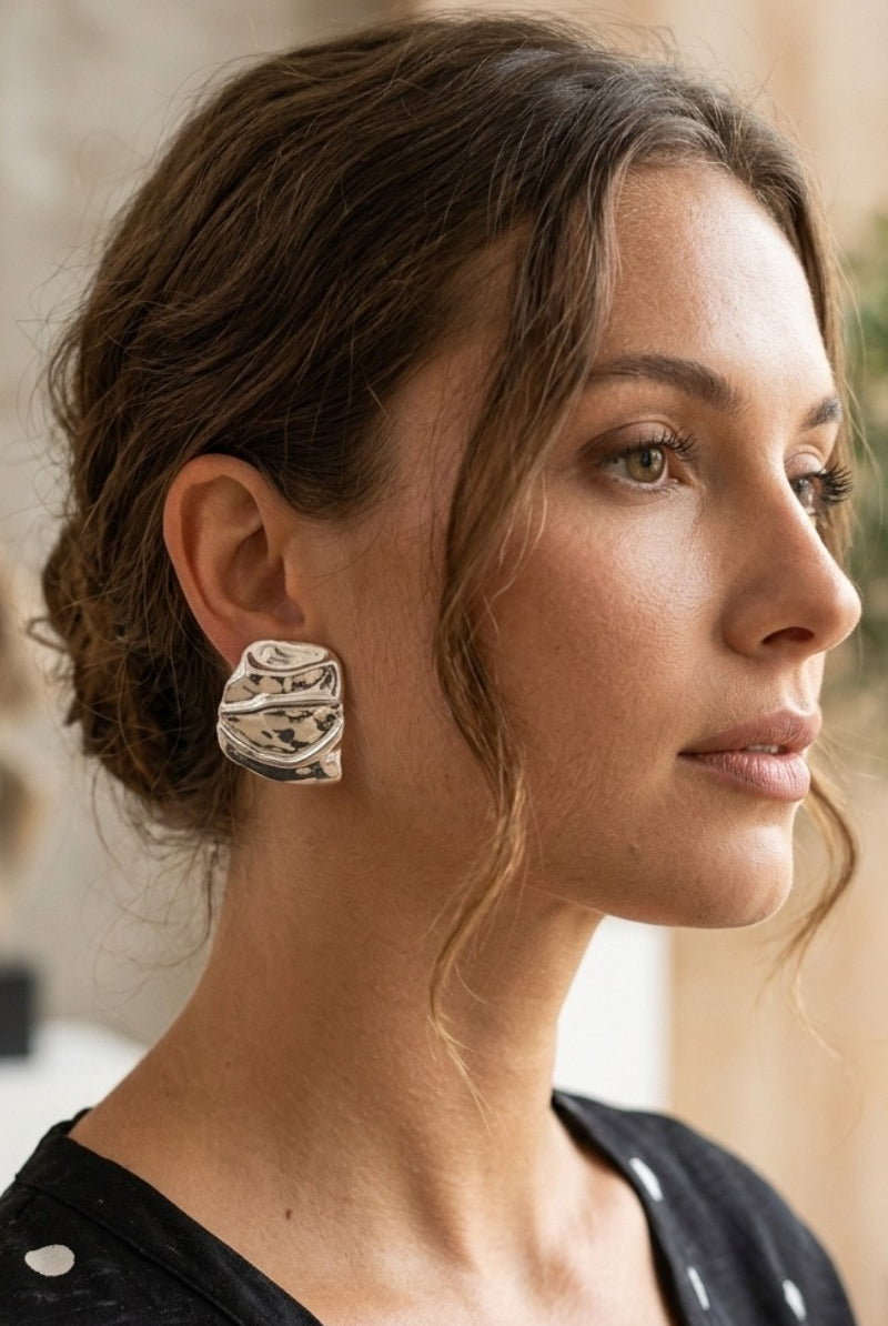 Model wearing liquid silver square statement stud earrings, view 4