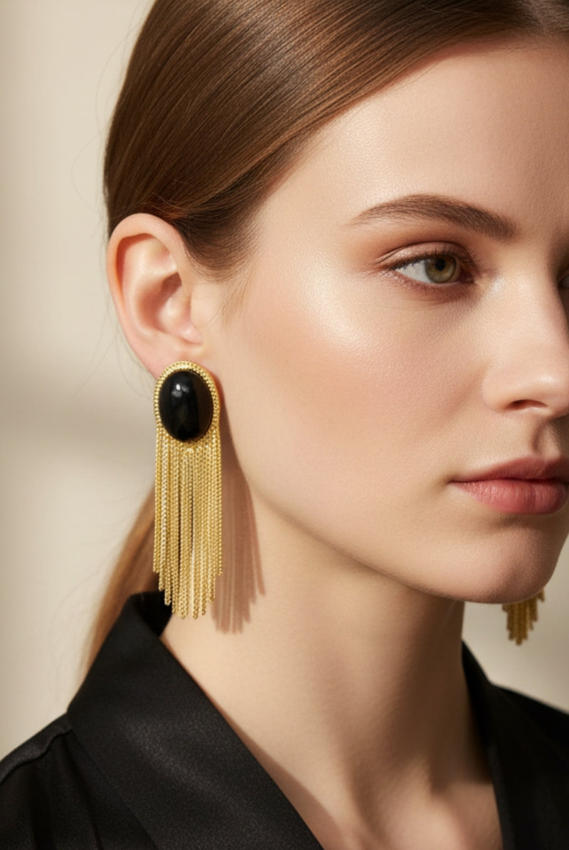Eclipse Vintage Tassels Earrings featuring a high-luster jet black glass bead and elegant gold-plated chain fringe. Sophisticated geometric statement jewelry with a modern vintage flair.