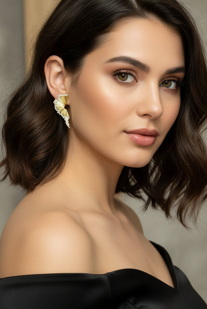 Handcrafted textured gold studs with organic fan shape for modern chic style in New York.
