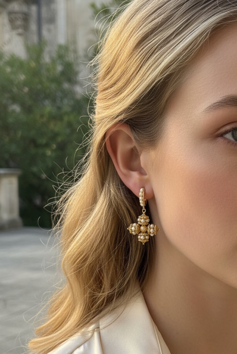 All Glows Opulence earrings featuring a high-luster large round shell pearl cradled in a sculptural 18K gold-plated molten setting.