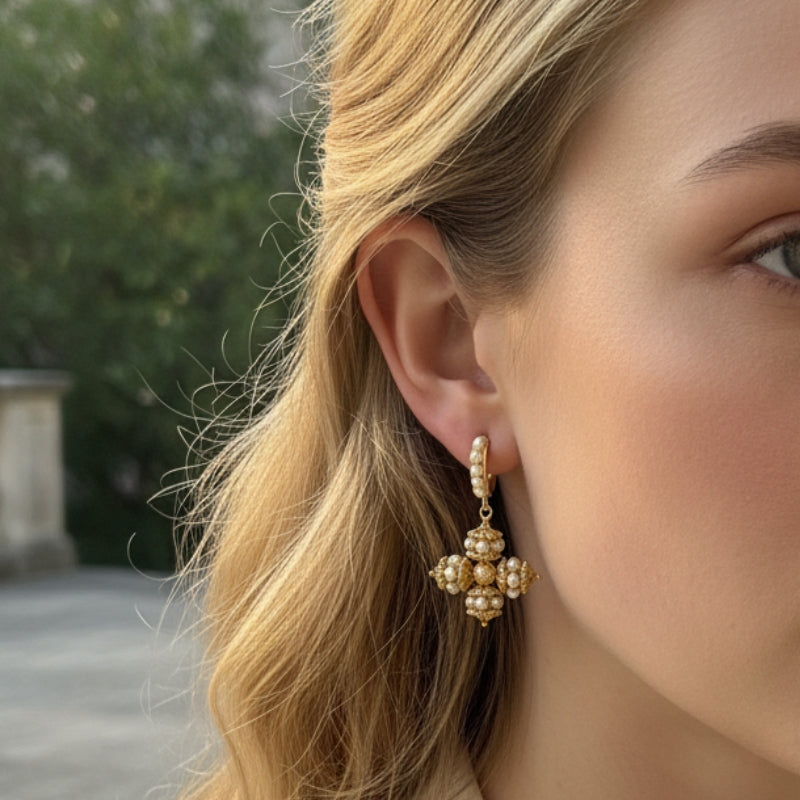 Close-up side view of a model wearing an Opulence faux pearl drop earring