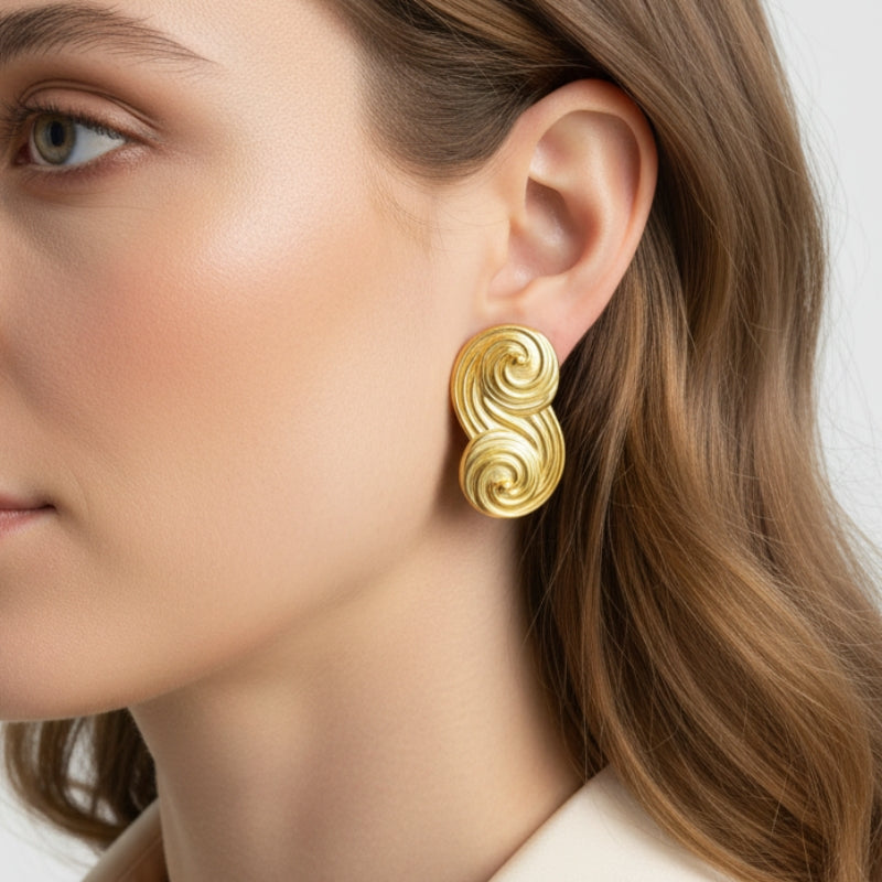 Side profile view of Seraphina small sculptural gold earrings, showcasing the unique swirl design and premium 18K gold plating.