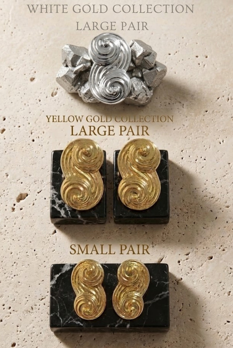 An elegant display of the Seraphina collection, featuring small and large pairs in both yellow gold and white gold on marble bases.