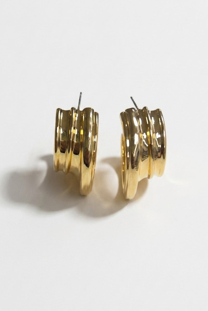 Pair of triple-ribbed wave hoop earrings on a white background