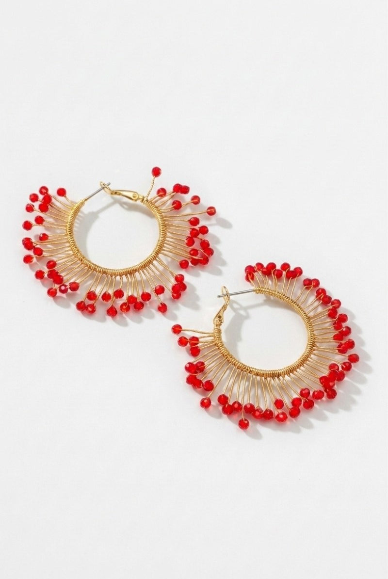 Pair of solburst wire-wrapped beaded sunburst hoop earrings in the Crimson variant on a white background