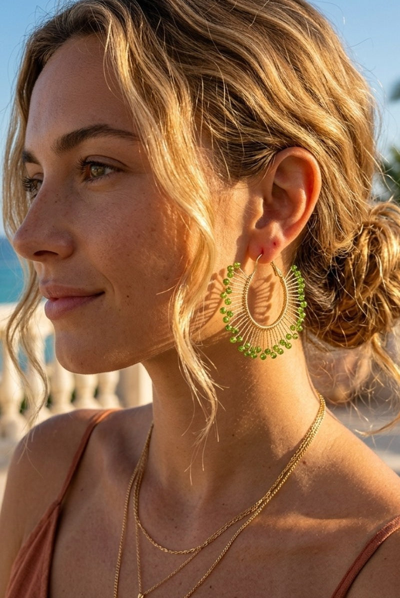 Model wearing solburst wire-wrapped beaded sunburst hoop earrings in the Olive variant, view 2