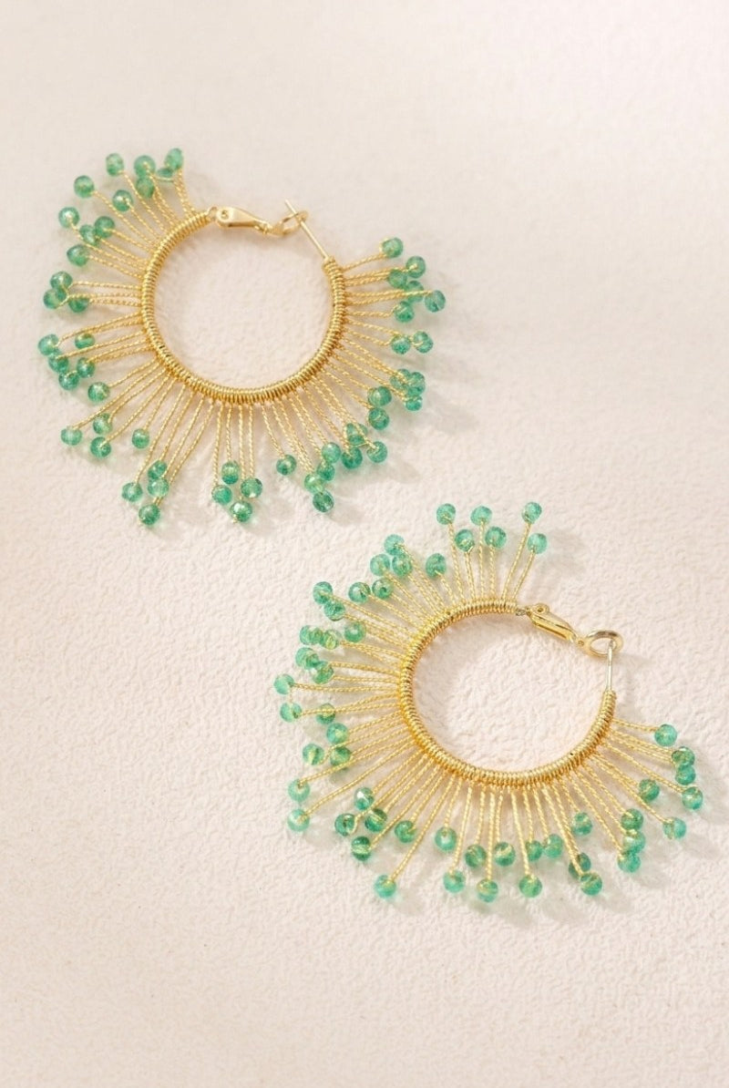 Solburst wire-wrapped beaded sunburst hoop earrings in the Seafoam variant on a warm beige background