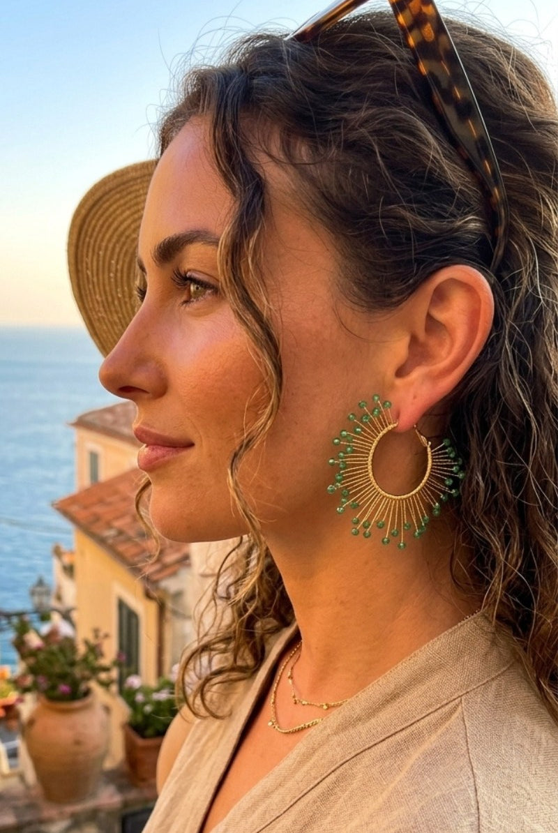 Model wearing solburst wire-wrapped beaded sunburst hoop earrings in the Seafoam variant, view 3