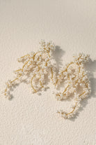 All Glows 18K gold plated earrings with shell pearls, showcasing a contemporary baroque aesthetic.