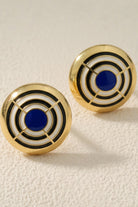 Large cobalt blue and white enamel concentric circle dôme earrings, showing oversized fit and high-shine finish.