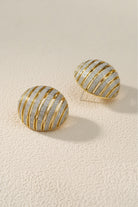 Chunky ribbed two-tone gold and silver dome earrings, mixed metal jewelry trend 2026.