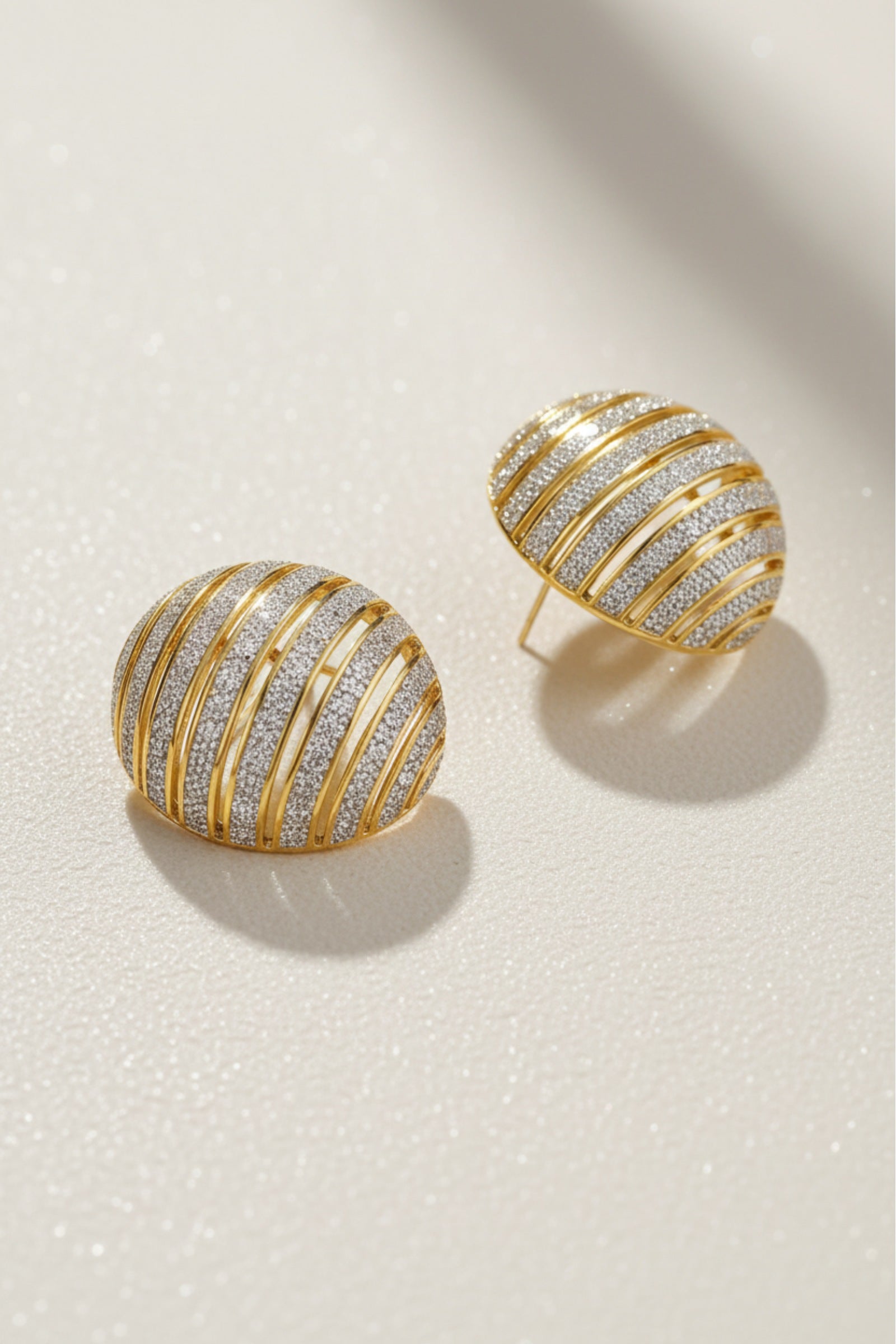 Chunky ribbed two-tone dôme earrings in gold and silver, styled for a mob wife aesthetic with a bold architectural texture.
