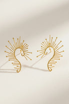 18K gold plated sunburst ear crawlers featuring delicate wire rays, styled as a statement sculptural ear climber.