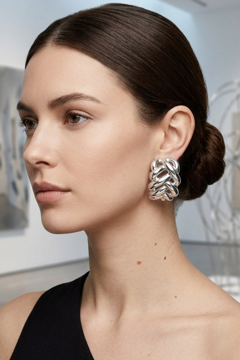 Model wearing braided liquid silver half-hoop earrings, view 4