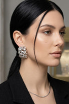 Model wearing braided liquid silver half-hoop earrings, view 5