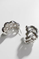 Pair of braided liquid silver half-hoop earrings on a white background