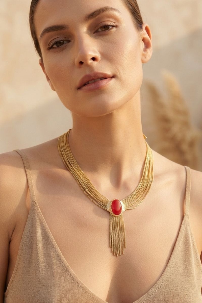 Eclipse red crystal necklace worn with a neutral sleeveless evening look