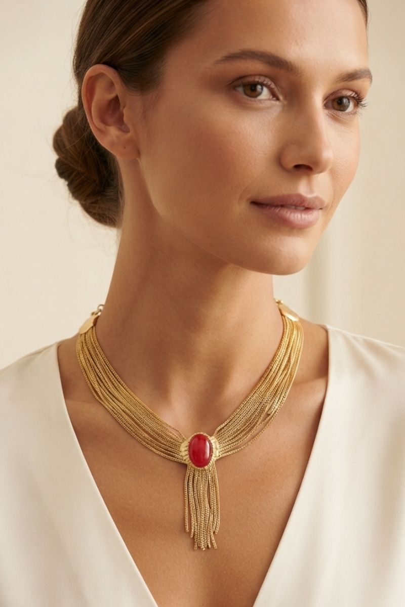 Eclipse red statement necklace worn with an ivory V-neck dress