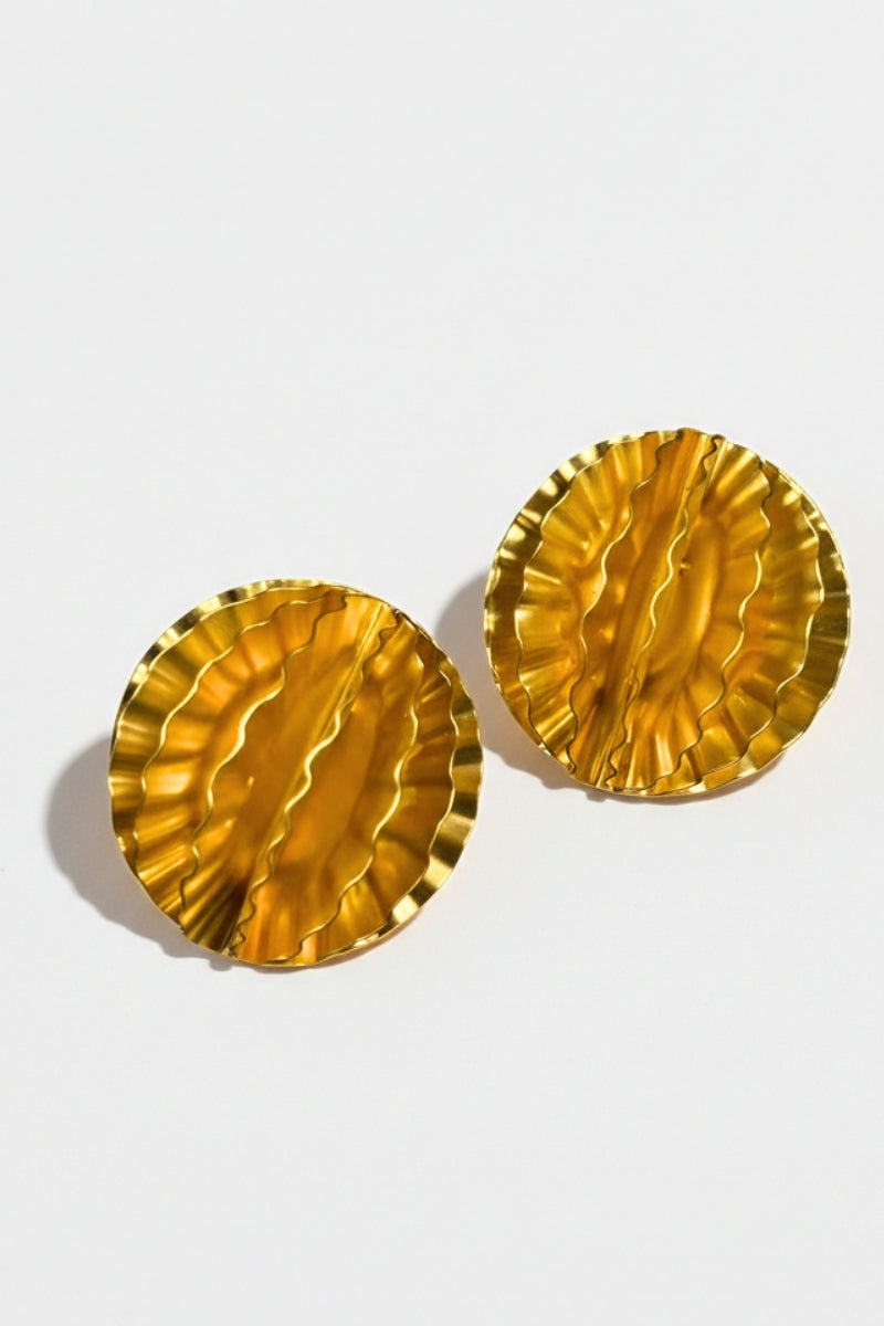 Close-up of gold-plated honeycomb earrings showing the intricate pleated texture and high-shine metallic finish.
