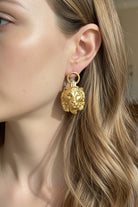 Model wearing bold lion head door knocker earrings, a perfect statement for Los Angeles streetwear fashion.