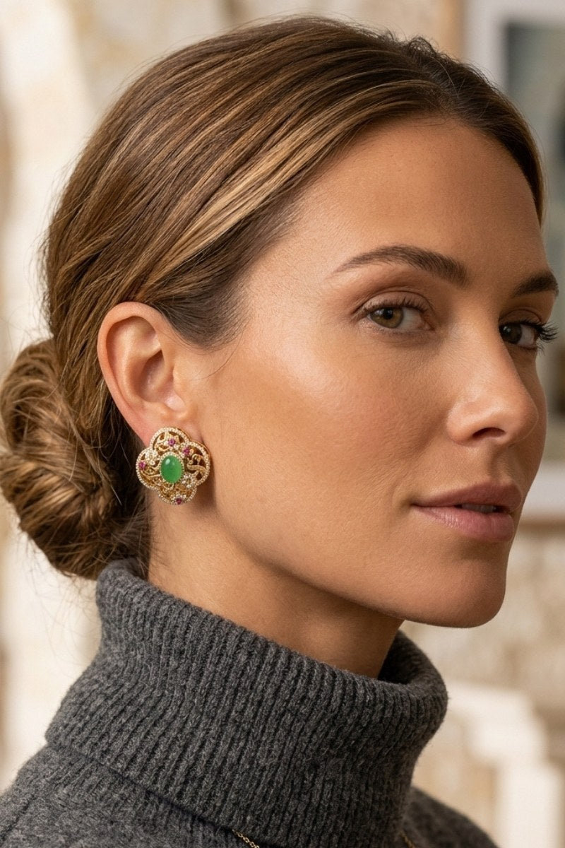 Model wearing green crystal quatrefoil stud earrings, view 2