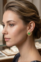 Model wearing green crystal quatrefoil stud earrings, view 5