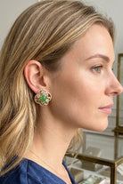 Model wearing green crystal quatrefoil stud earrings, view 1