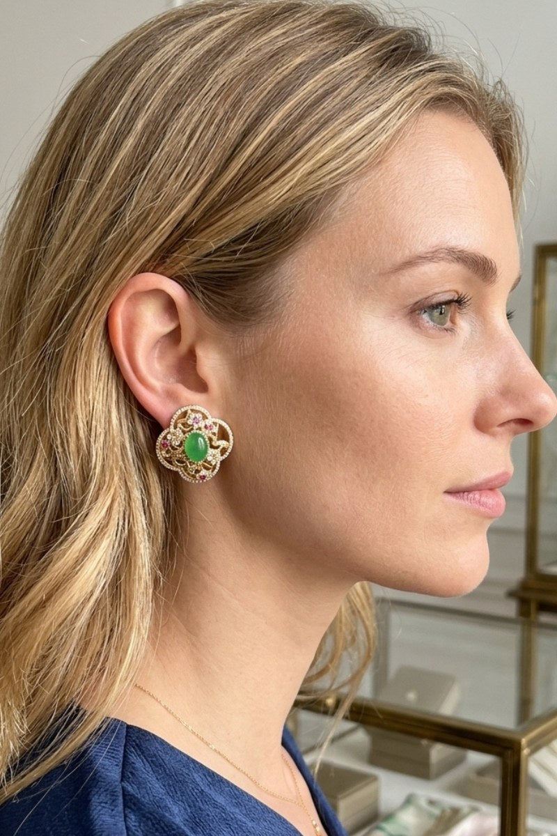Model wearing green crystal quatrefoil stud earrings, view 1