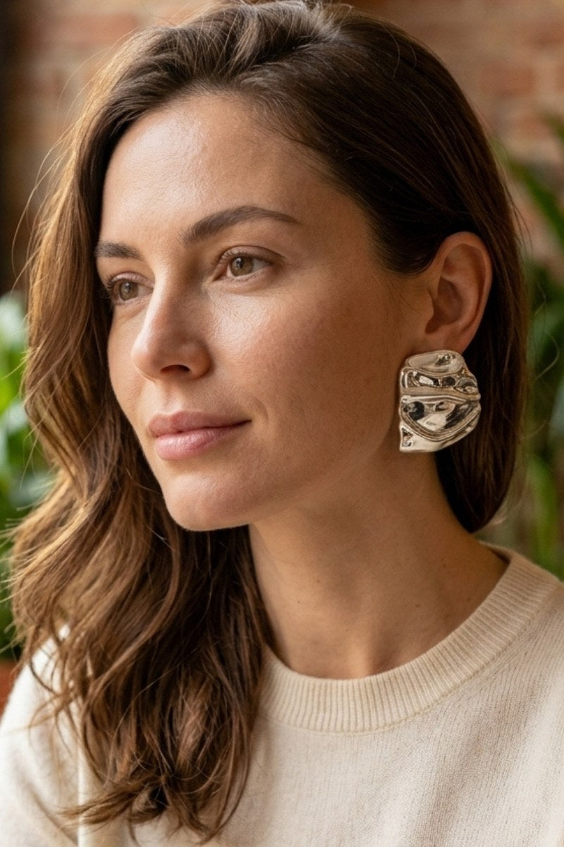 Model wearing liquid silver square statement stud earrings, view 2