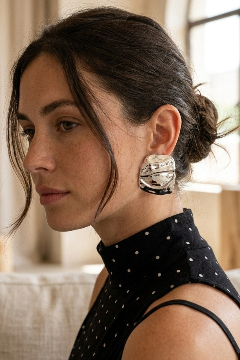 Model wearing liquid silver square statement stud earrings, view 3