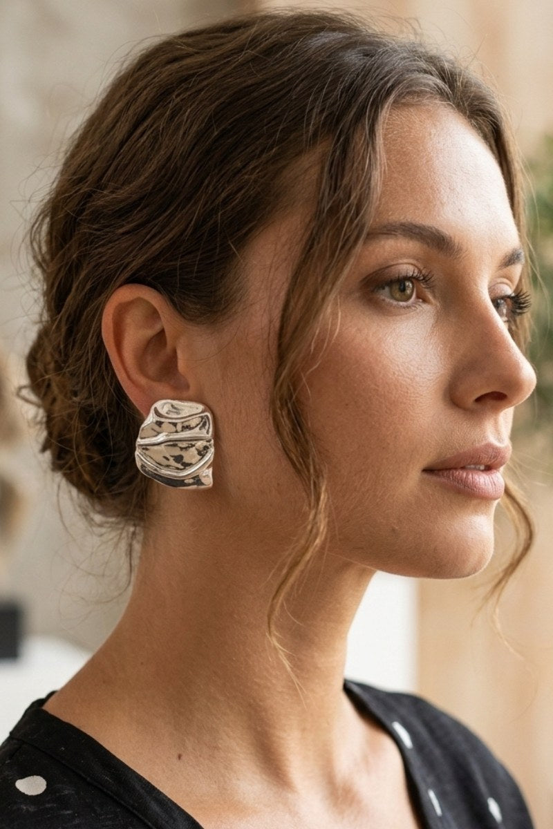 Model wearing liquid silver square statement stud earrings, view 4