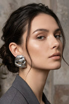 Model wearing liquid silver square statement stud earrings, view 5