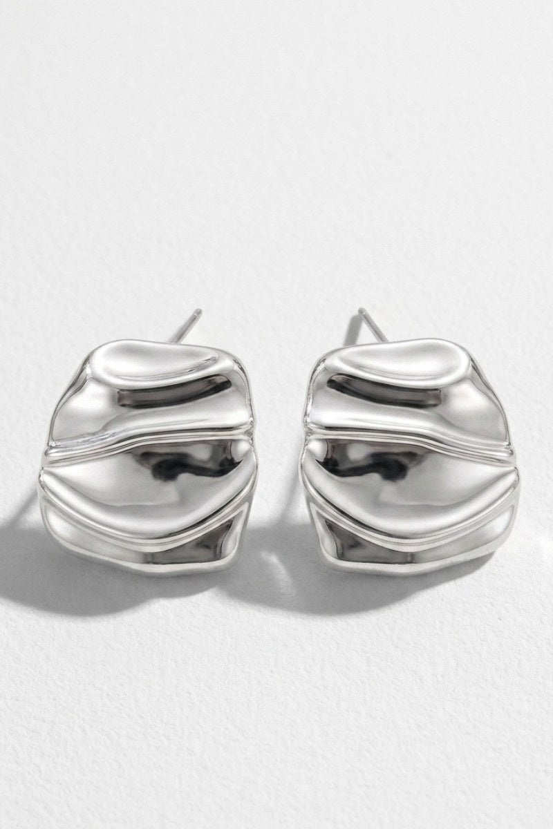 Pair of liquid silver square statement stud earrings on a white background