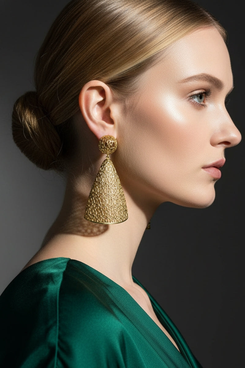 Side profile of a woman in a green silk gown wearing All Glows 18K gold lattice drop earrings for a luxury gala event.