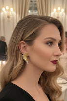 Luxury gold fan statement earrings for high-end evening gala and red carpet in Paris.