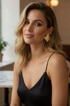 Elegant model wearing the Mirage Earrings, an ideal statement accessory for everyday luxury and sophisticated outfits.