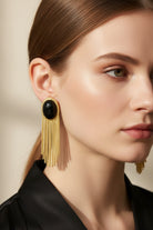 Eclipse Vintage Tassels Earrings featuring a high-luster jet black glass bead and elegant gold-plated chain fringe. Sophisticated geometric statement jewelry with a modern vintage flair.