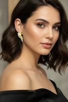 Handcrafted textured gold studs with organic fan shape for modern chic style in New York.