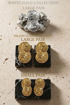 An elegant display of the Seraphina collection, featuring small and large pairs in both yellow gold and white gold on marble bases.